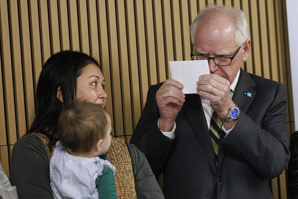 Walz smiles and gestures