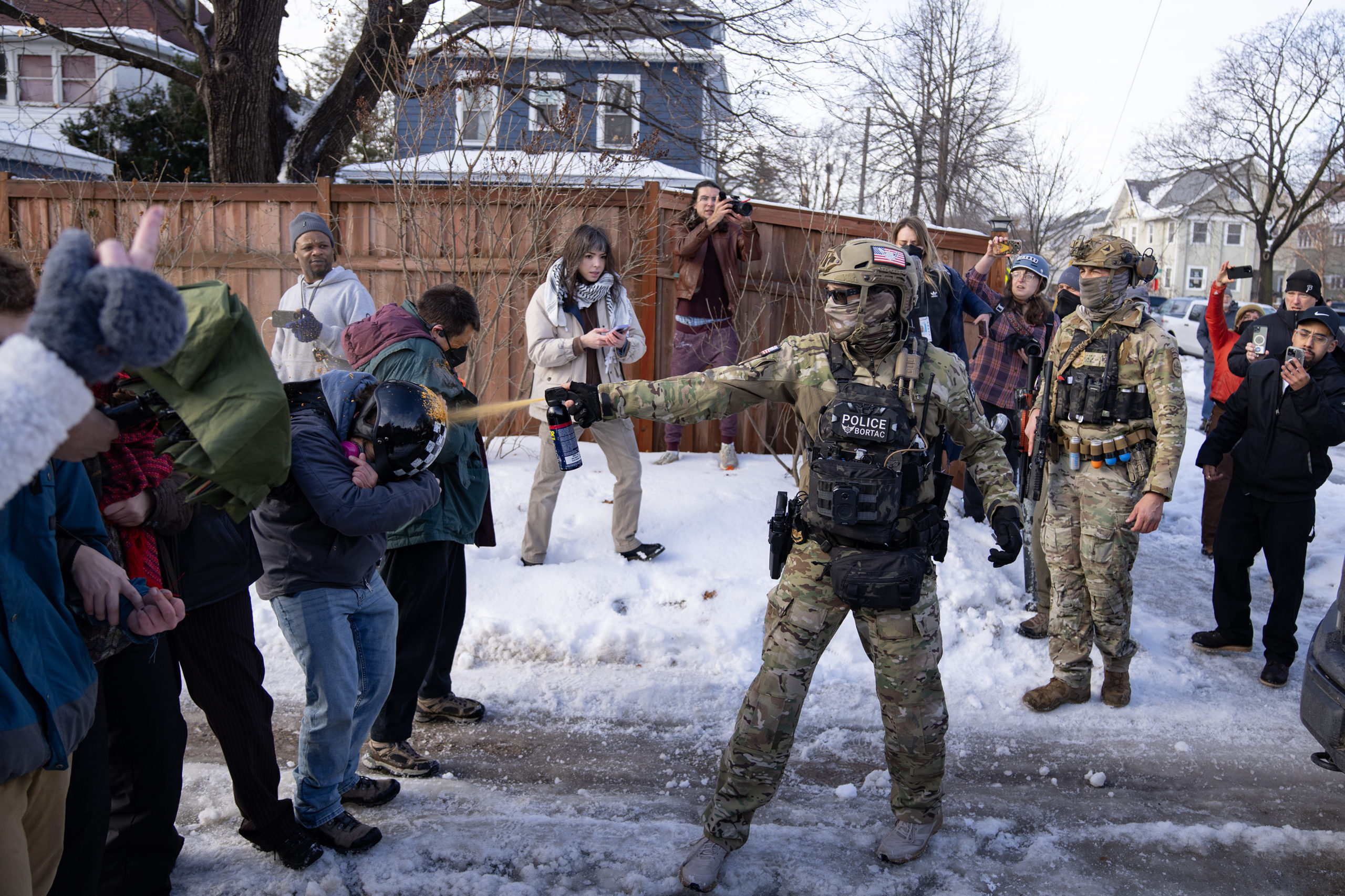 ICE agents and protesters face off in two lines at the scene of the fatal shooting of Renee Nicole Good by an ICE agent in Minneapolis, Minnesota, on January 7, 2026.