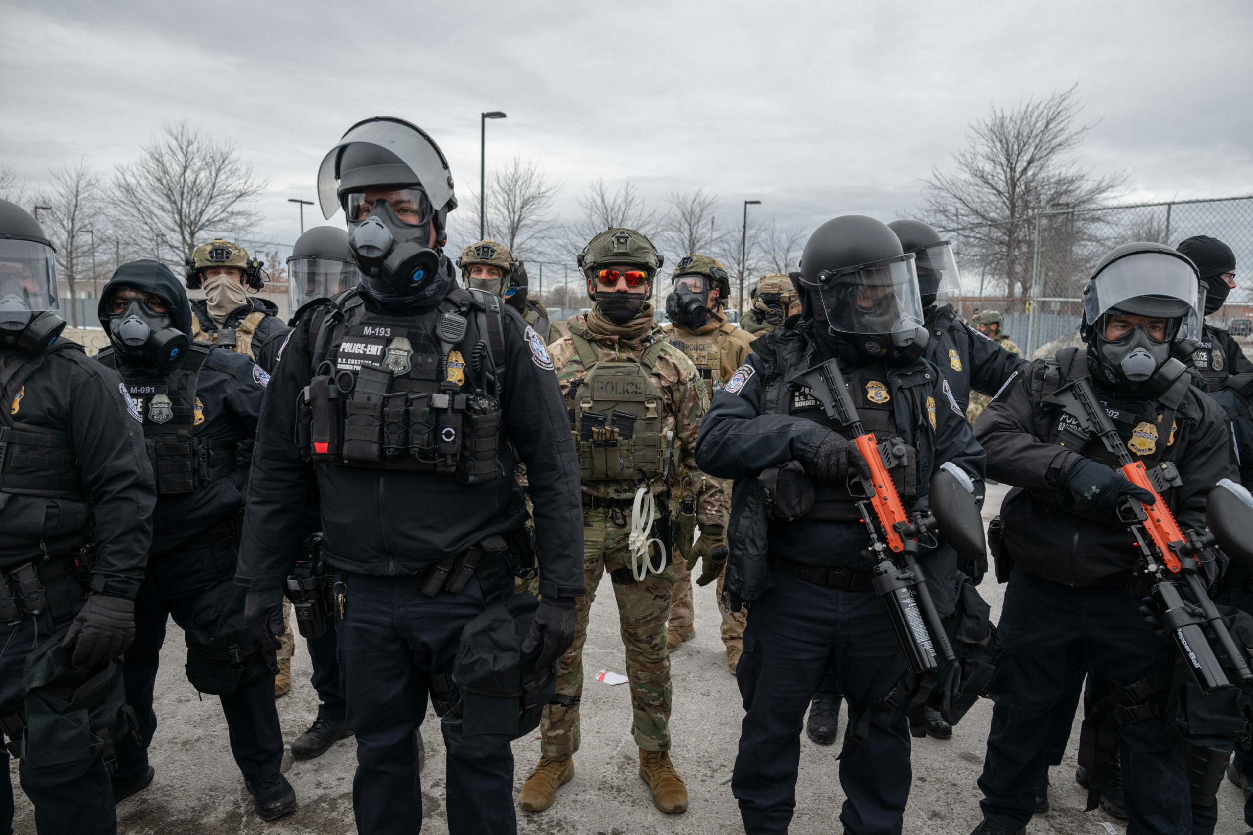ICE agents stand at the ready
