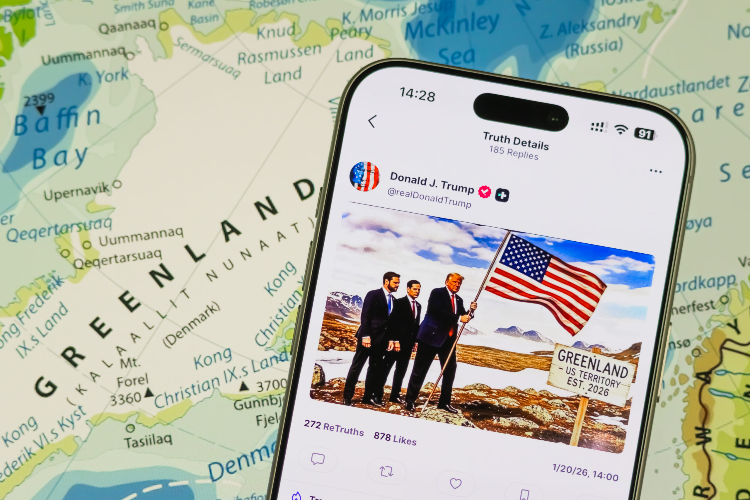 A smartphone displays a post by Trump on his Truth Social platform 