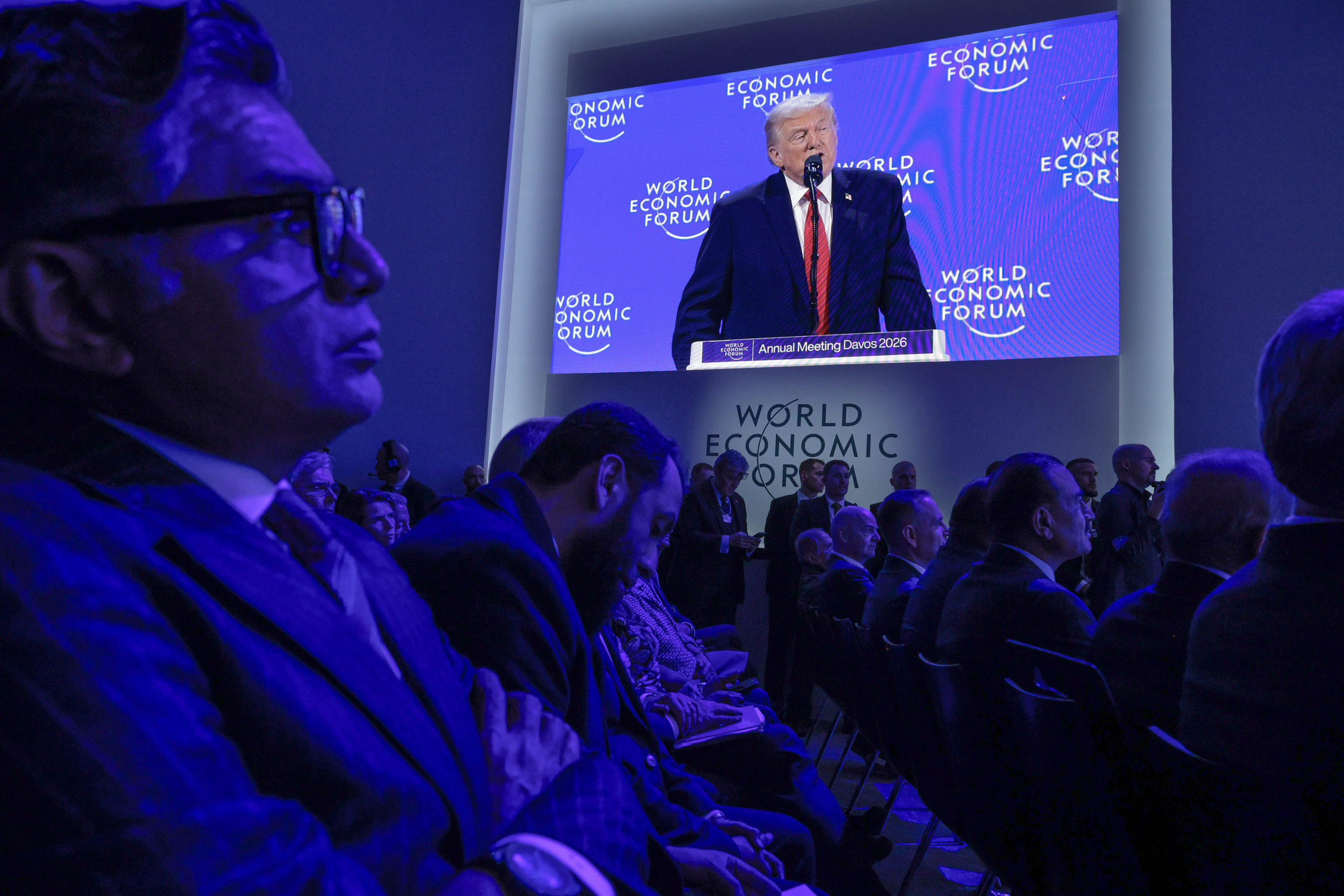 Trump on a big screen looming over the audience in Davos. 