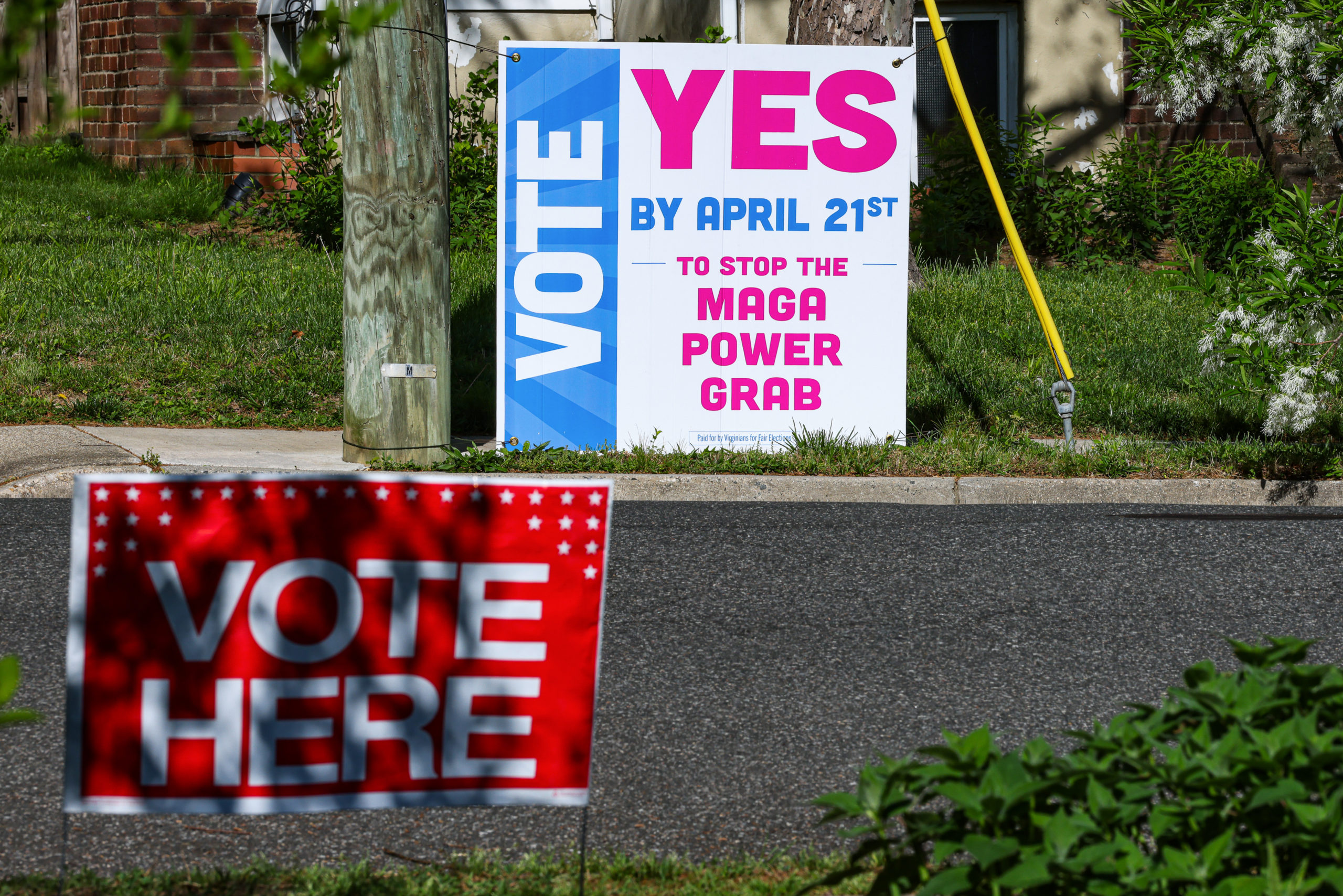 "Vote Here" and "Vote Yes" signage during a special election in Arlington, Virginia, on April 21, 2026.