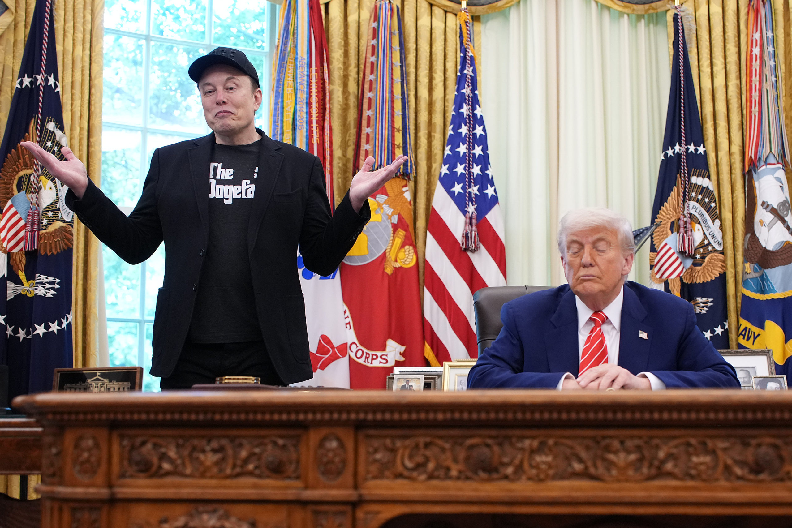 Elon Musk standing beside Trump in the Oval Office.