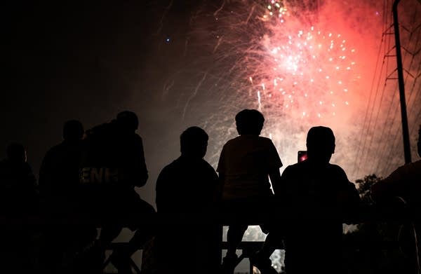 a group of people view fireworks