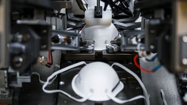 A machine produces respiratory masks.