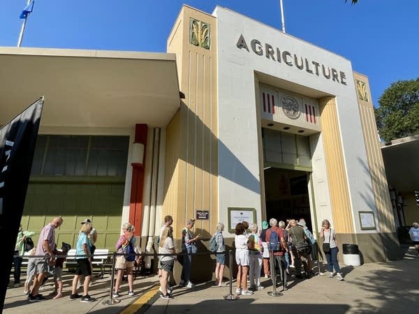 people wait in line to see the crop art on display at the minnesota state fair