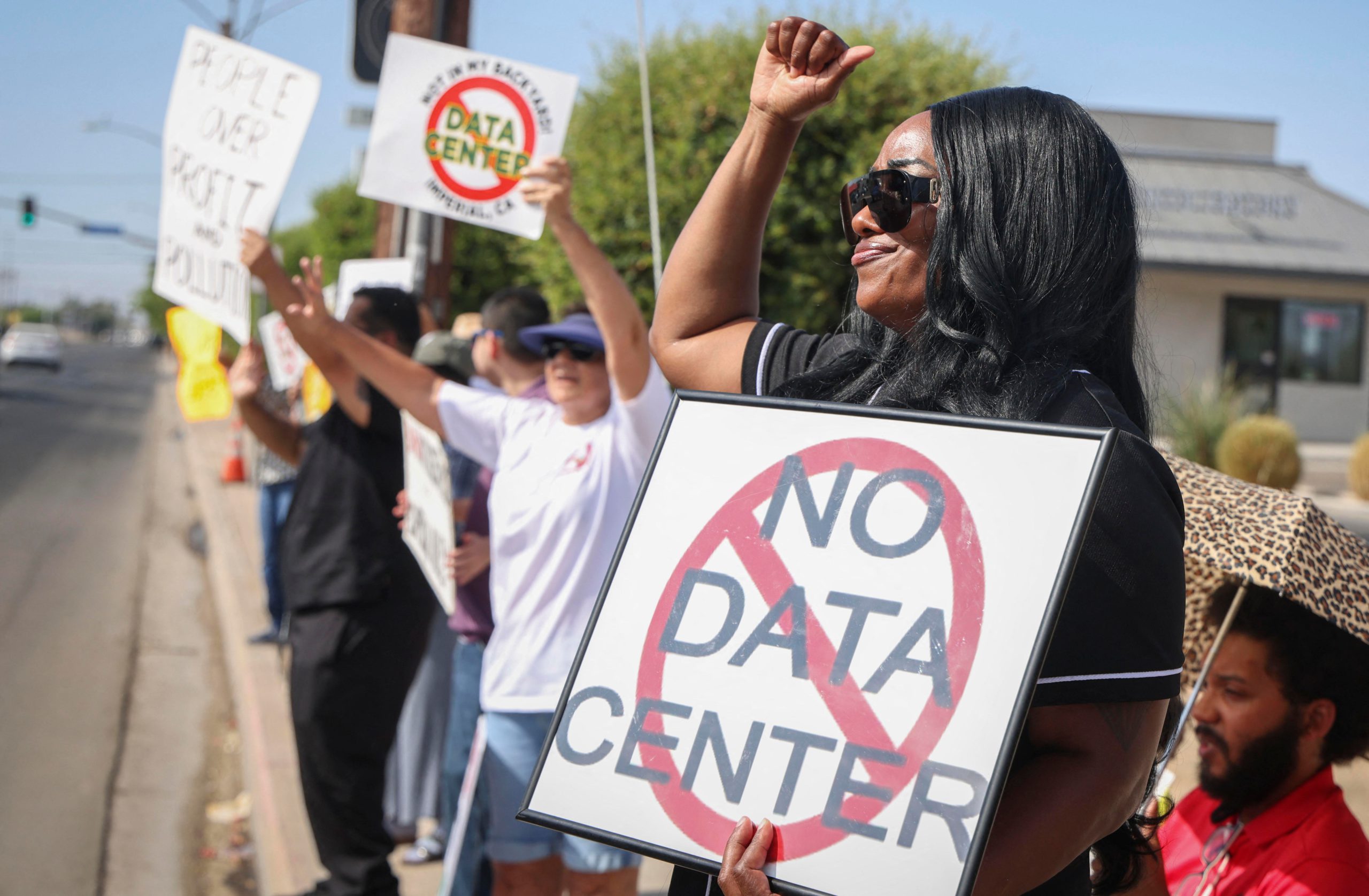 Protesters hold signs reading “No Data Centers.”