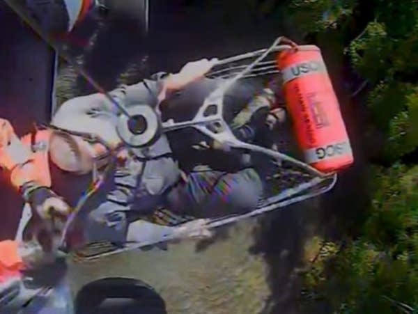 A man is lifted to a helicopter
