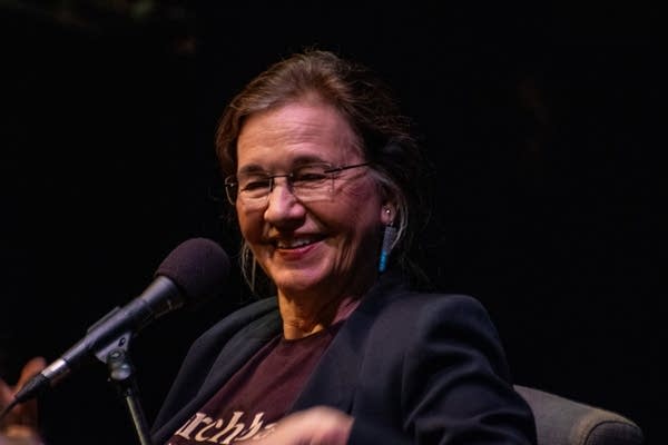 A woman speaks with a microphone.