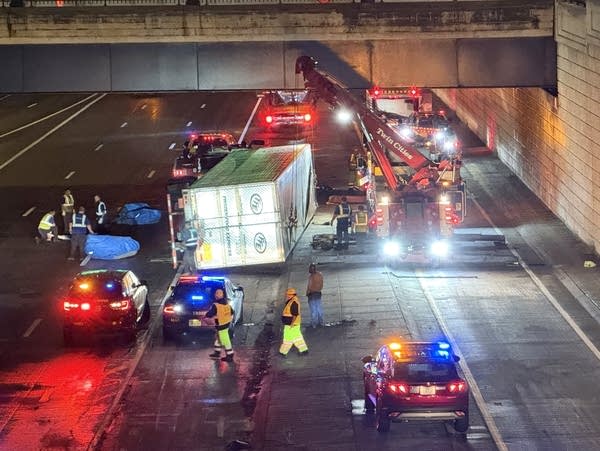 Crews work to remove a rolled-over semi