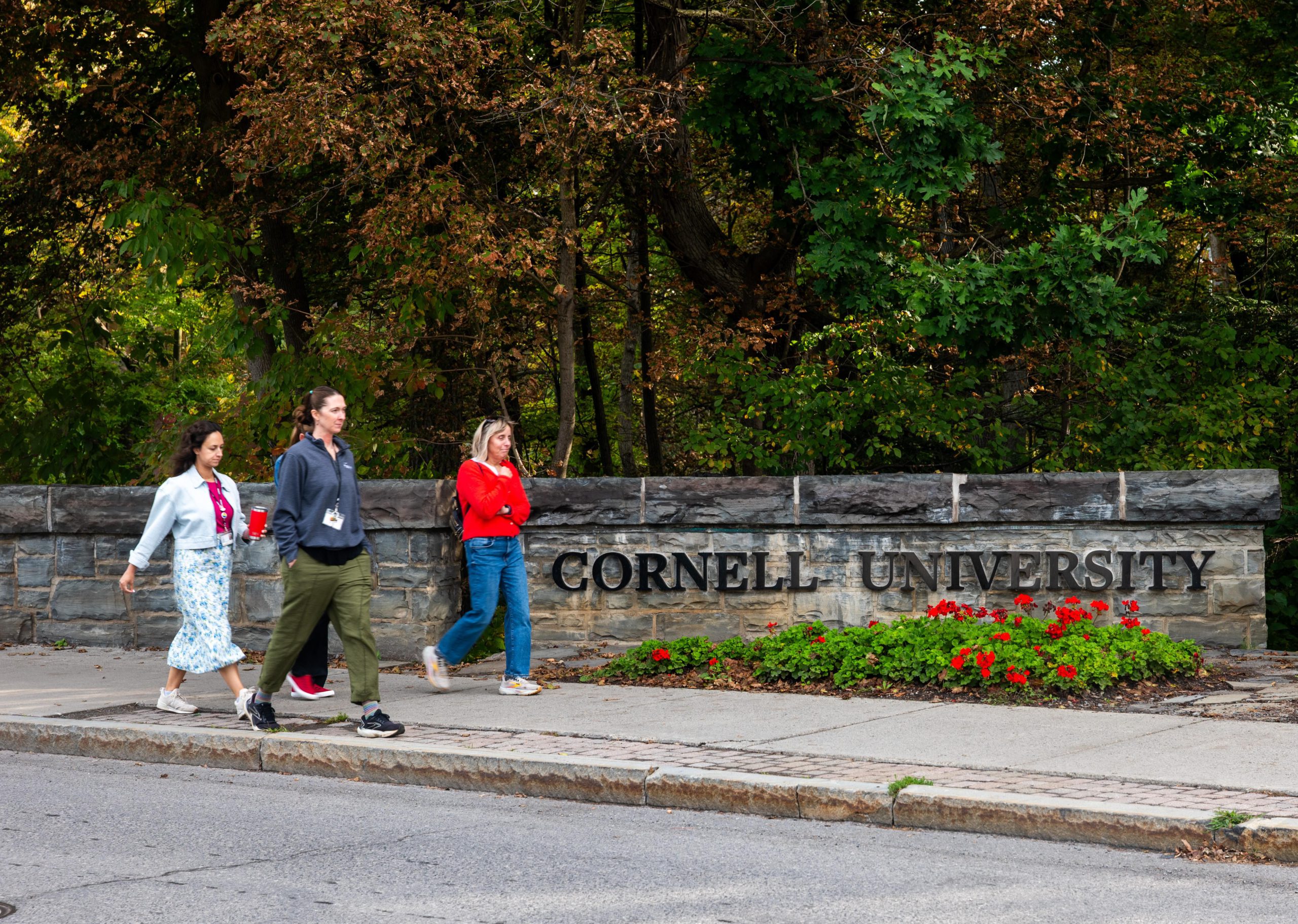 People walk on the campus of Cornell University.