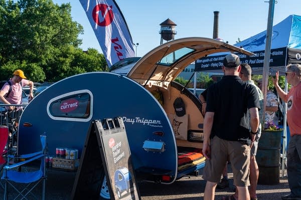 People look at a camper trailer