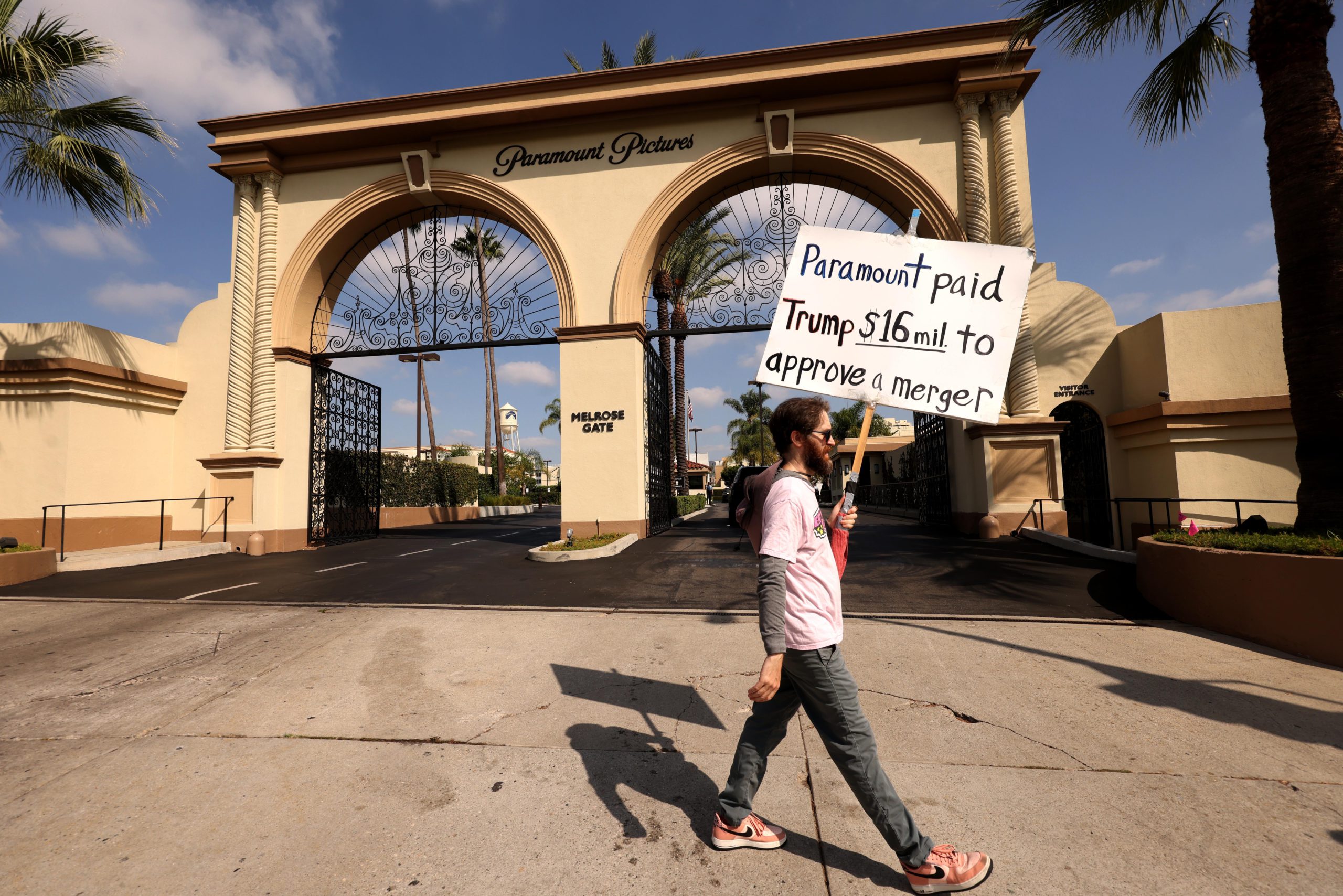 An activist protests the merger of Paramount and Warner Bros. Discovery