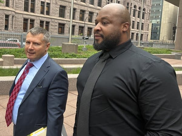 two men stand outside Henn jail
