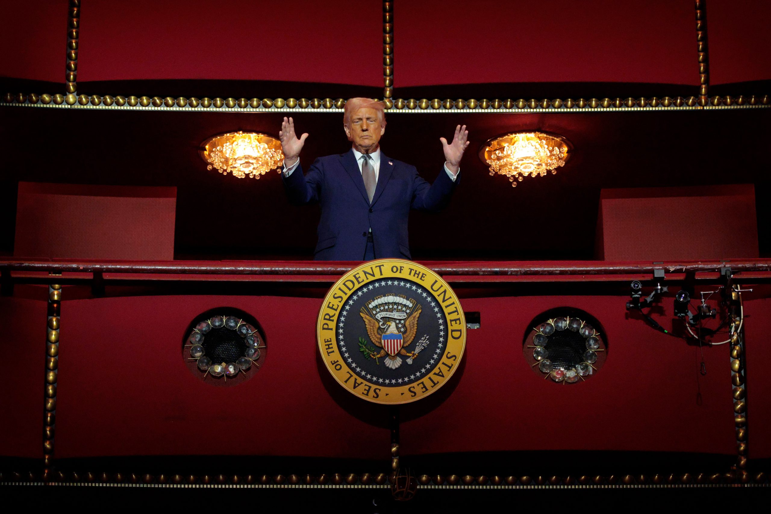 Trump looks down from the Presidential Box in an opera house
